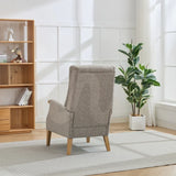 Beige thistle chair with wooden legs in bright living room with bookshelf and potted plant