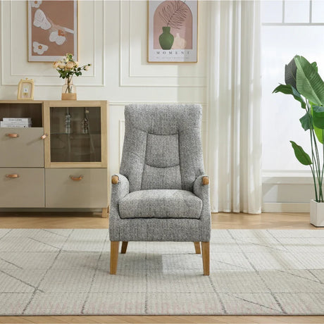 Thistle chair in stone fabric with wooden legs, placed in a bright modern living room