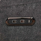 Close-up of power and USB control panel on dark grey swivel glide chair fabric