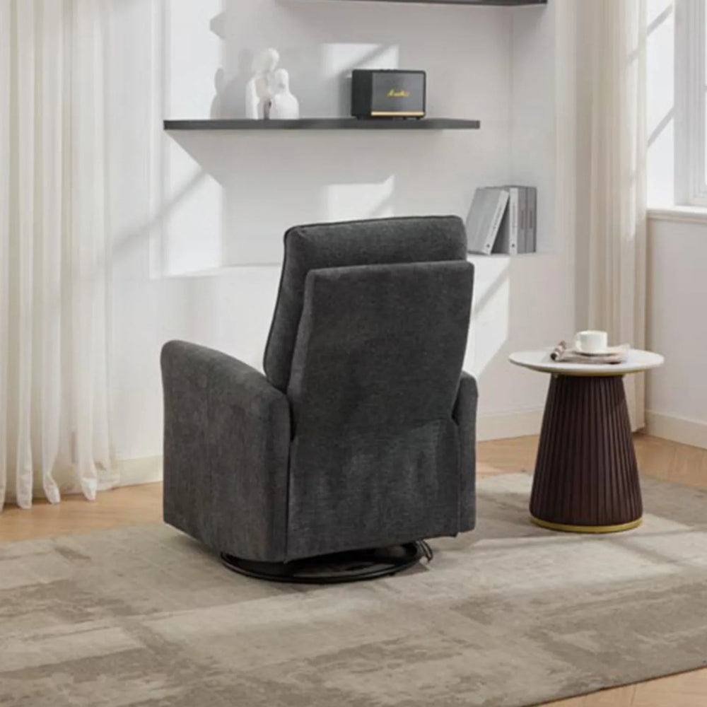 Dark grey swivel glide chair with high backrest in living room beside round side table