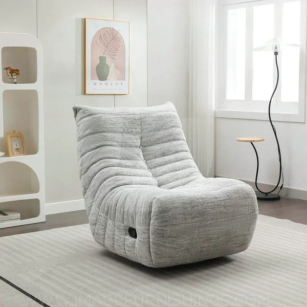 Light grey reclining chair with tufted fabric in a modern living room setting