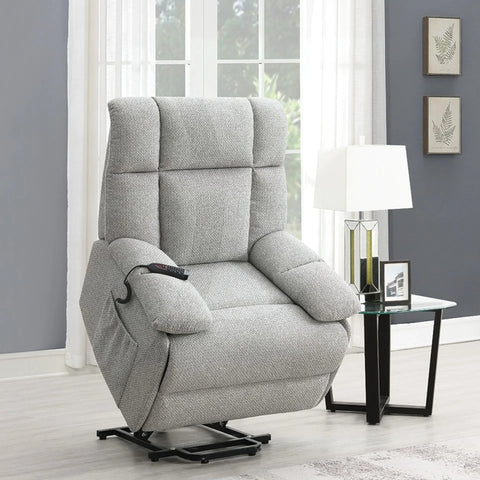 Grey lift and rise massage chair with remote in modern living room beside glass side table