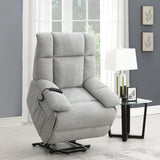 Grey lift and rise massage chair with remote in modern living room beside glass side table