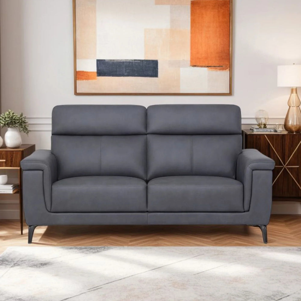 Graphite sofa with slim black legs in modern living room setting with abstract wall art