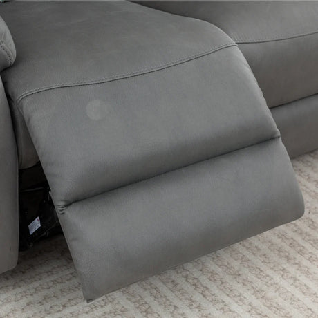Charcoal recliner chair footrest extended on beige patterned carpet