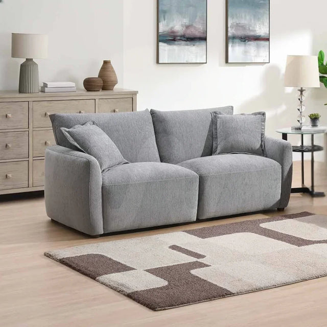 Light grey modular 2.5 seater sofa with cushions in modern living room setting