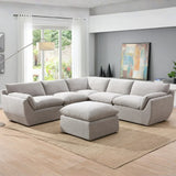 Light grey sectional sofa with matching ottoman in modern living room on beige rug