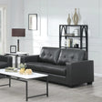 Black leather three-seater sofa with tufted back in modern living room setting