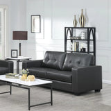 Black leather three-seater sofa with tufted back in modern living room setting