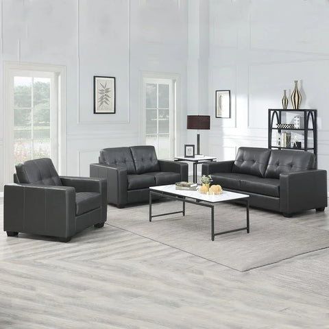 Black three-seater sofa with tufted backrest, set in a bright living room with modern decor