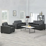 Black three-seater sofa with tufted backrest, set in a bright living room with modern decor
