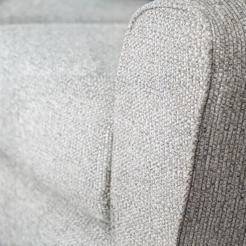 Close up of silver fabric sofa armrest with textured upholstery