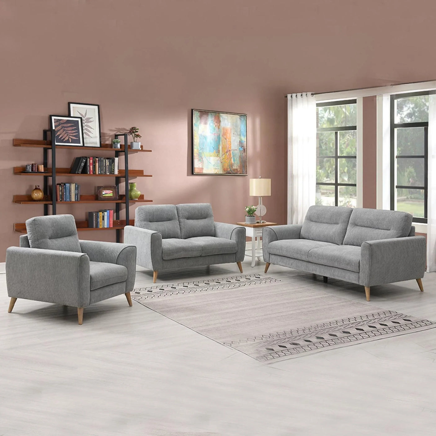 Grey fabric sofa set with armchair, loveseat, and three-seater in a modern living room