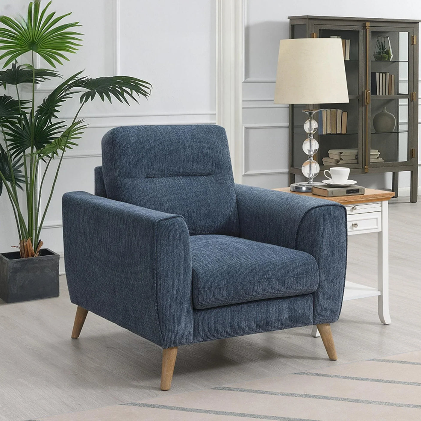 Blue fabric armchair with wooden legs in modern living room setting