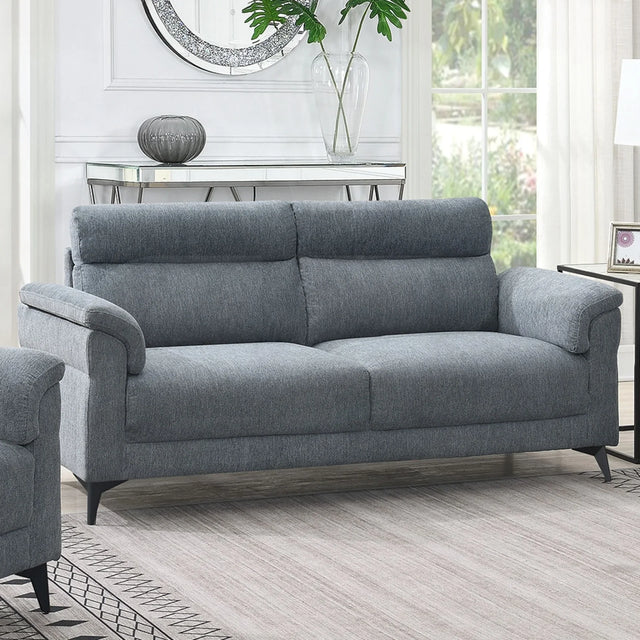 Grey fabric sofa with padded arms and metal legs in bright living room