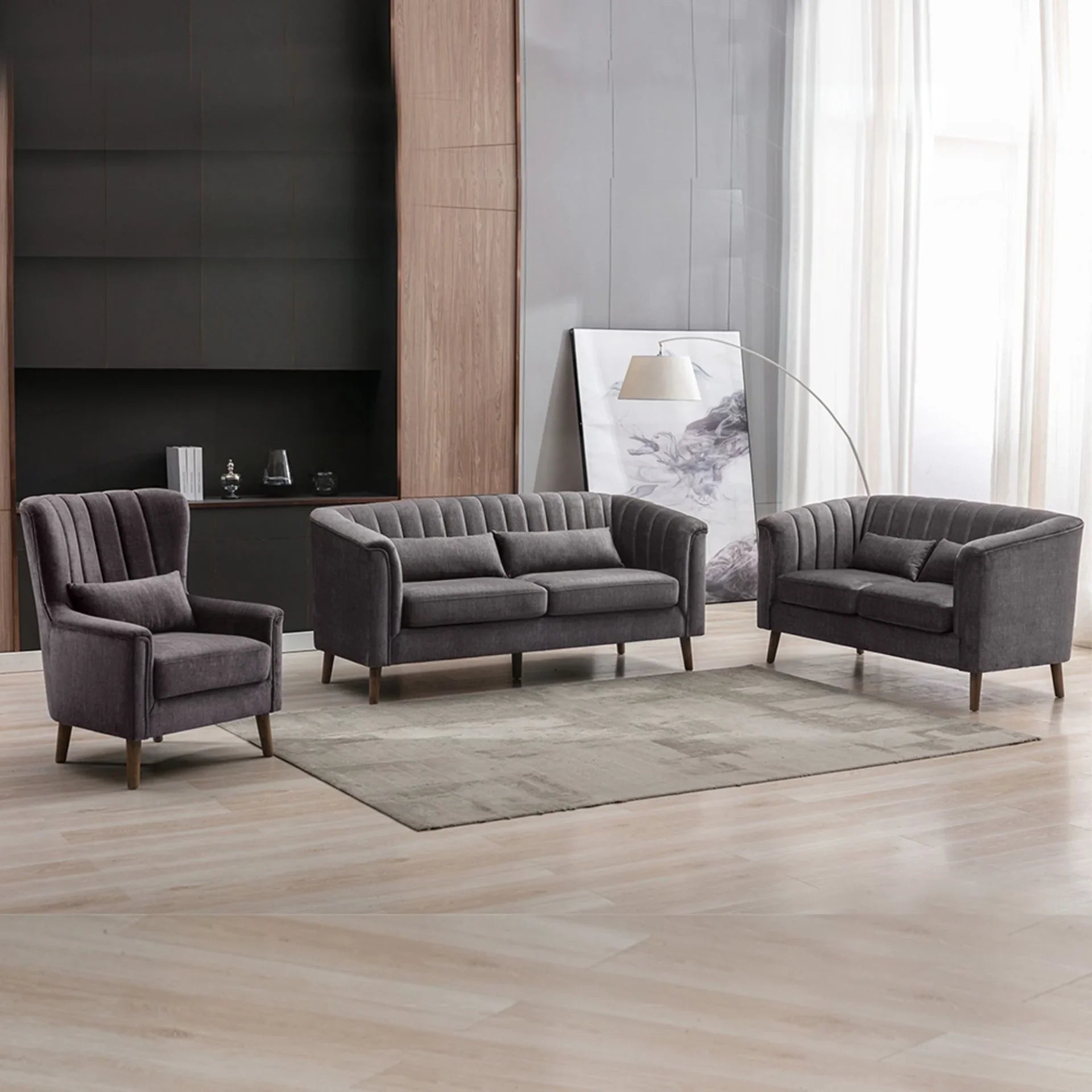 Graphite fabric sofa set with armchair and two-seater sofas on light wood floor in modern lounge
