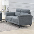 Grey fabric sofa with padded backrest and armrests in a modern living room setting