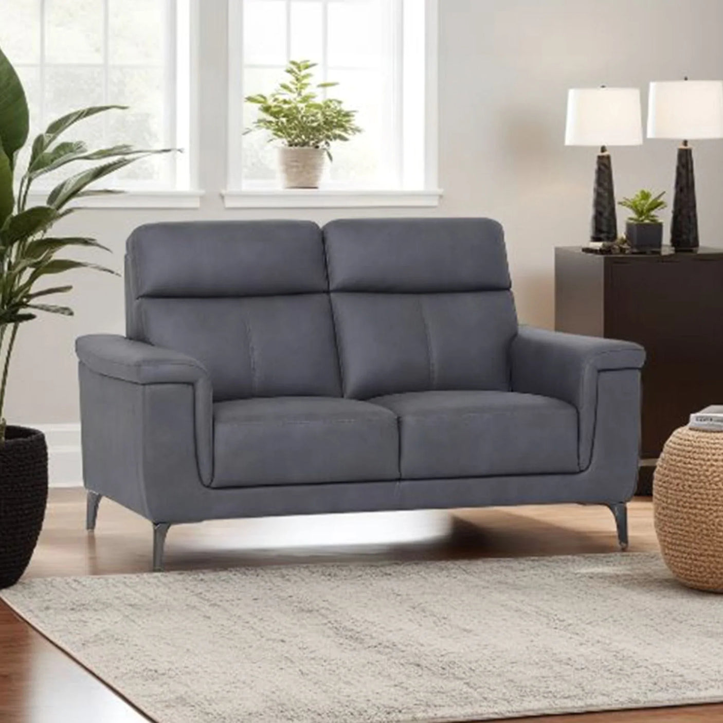 Graphite fabric sofa with metal legs in modern living room setting, next to plants and lamps