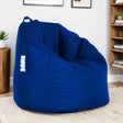Blue bean bag chair with handle and side label in modern living room setting