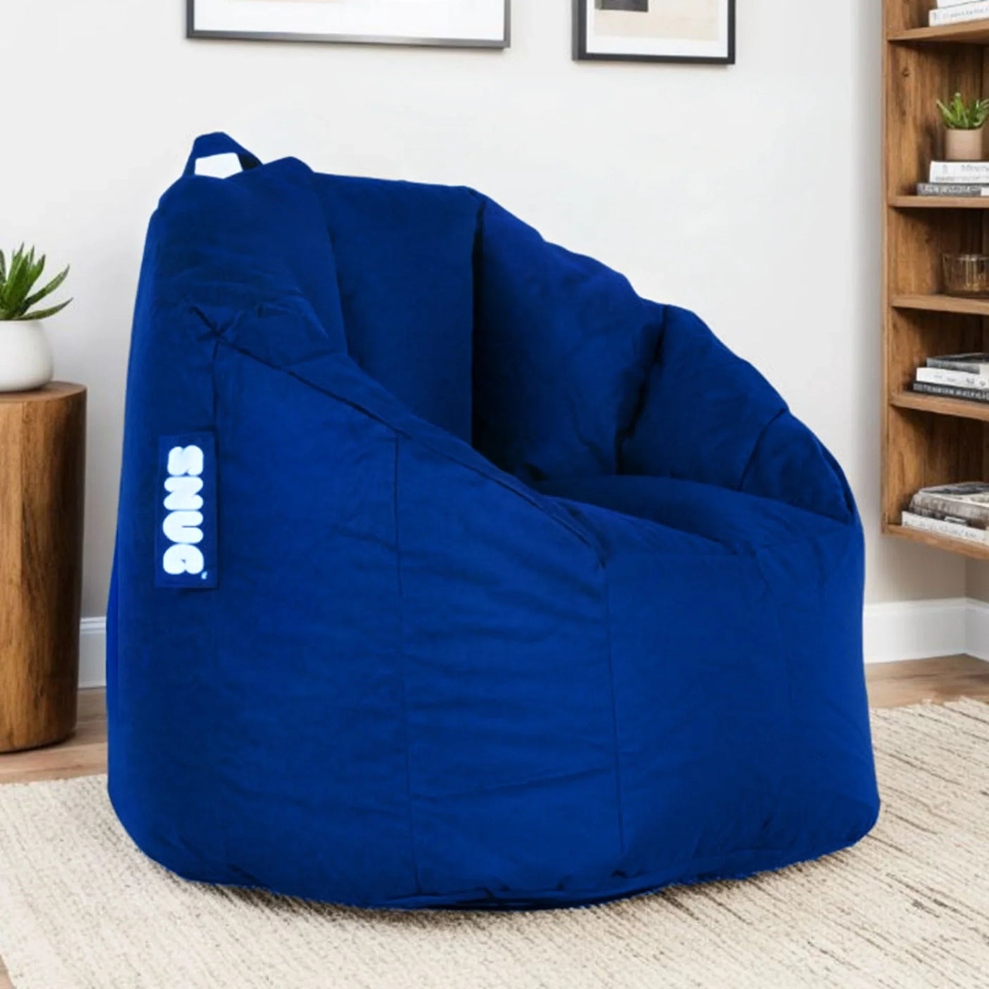Blue bean bag chair with handle and side label in modern living room setting