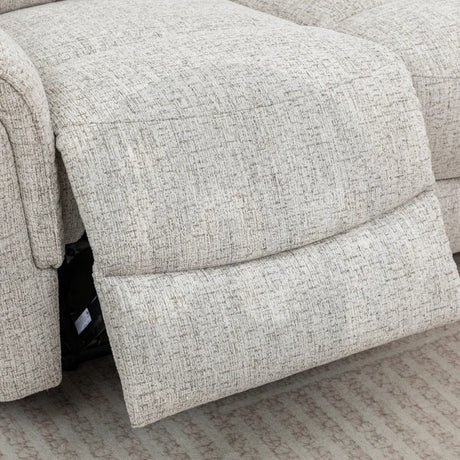 Beige fabric recliner sofa footrest extended on patterned carpet