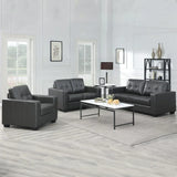 Black leather 2 seater sofa with armchair and 3 seater in modern living room setup