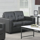 Black leather 2 seater sofa with tufted backrest in modern living room setting
