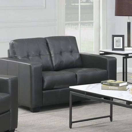Black leather 2 seater sofa with tufted backrest in modern living room setting