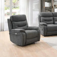 Dark grey fabric recliner armchair with matching piping in modern living room setting