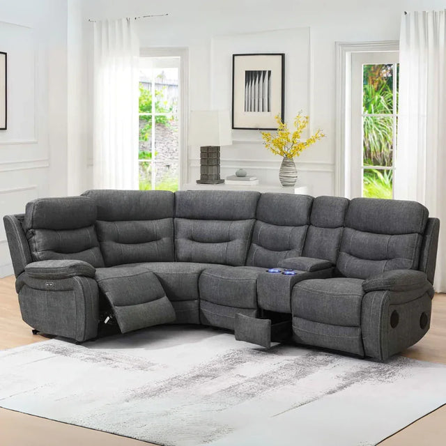 Dark grey tech reclining corner sofa with cup holders and console in modern living room