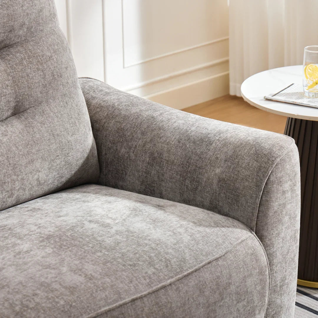 Close-up of grey fabric sofa arm and seat next to a modern round side table