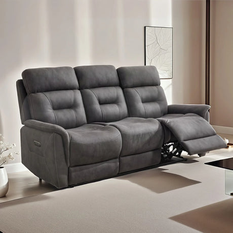 Grey three seater recliner sofa with padded seats in a modern living room setting