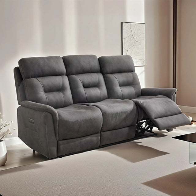 Grey three seater recliner sofa with padded seats in a modern living room setting