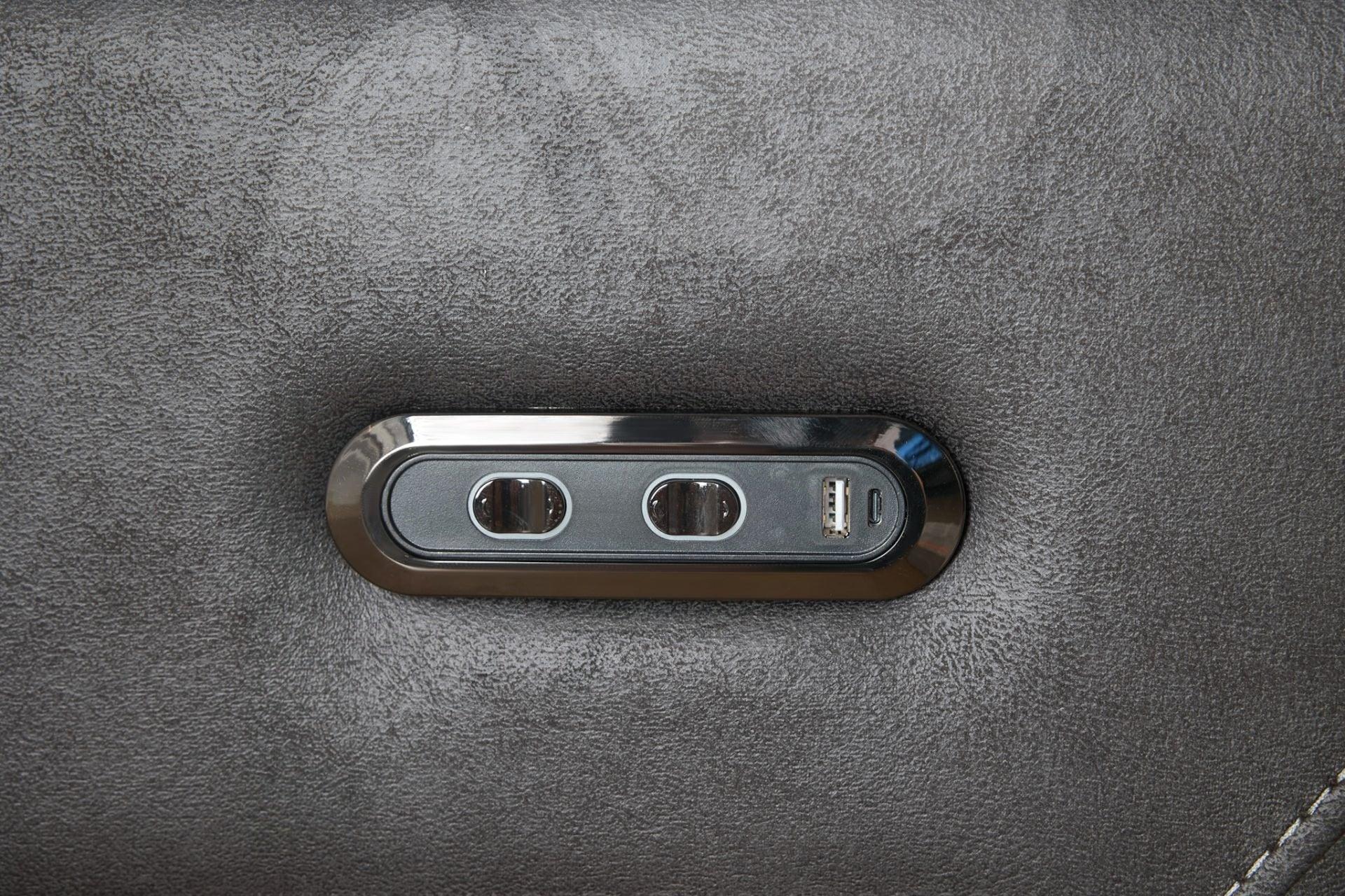 Grey sectional sofa control panel with USB port and buttons on fabric armrest