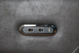 Grey sectional sofa control panel with USB port and buttons on fabric armrest