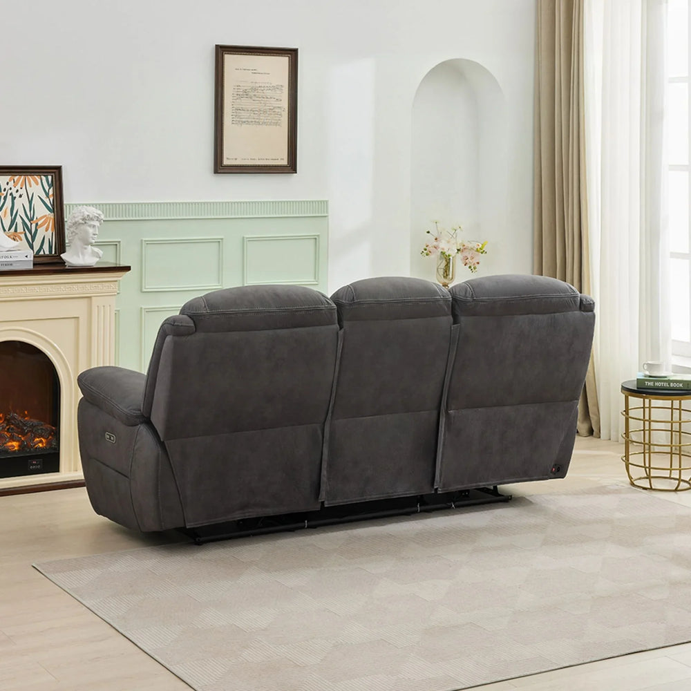 Gunmetal grey 3 seater sofa rear view in bright living room with fireplace and decor