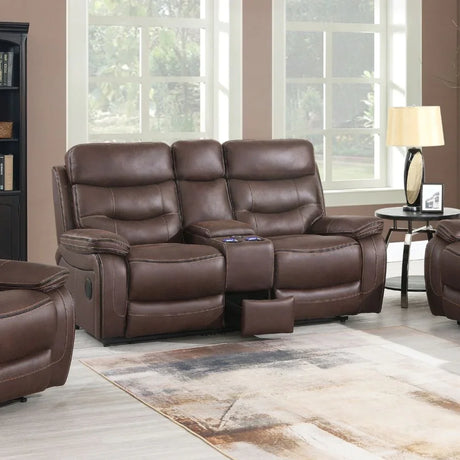 Brown leather reclining sofa with cup holders and center console in living room setting