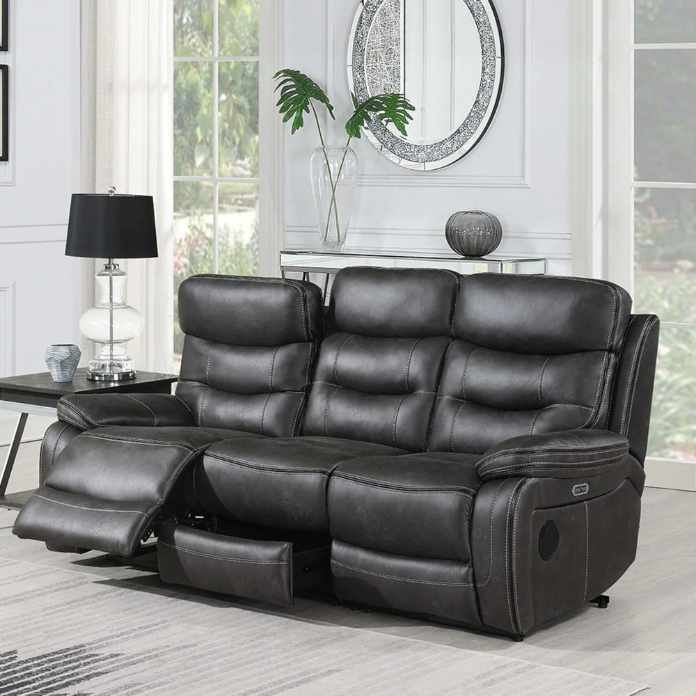 Grey three seater recliner sofa with footrest extended in bright living room setting