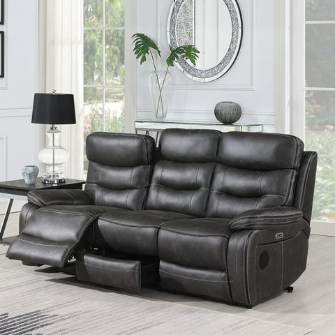 Grey three seater recliner sofa with footrest extended in bright living room setting
