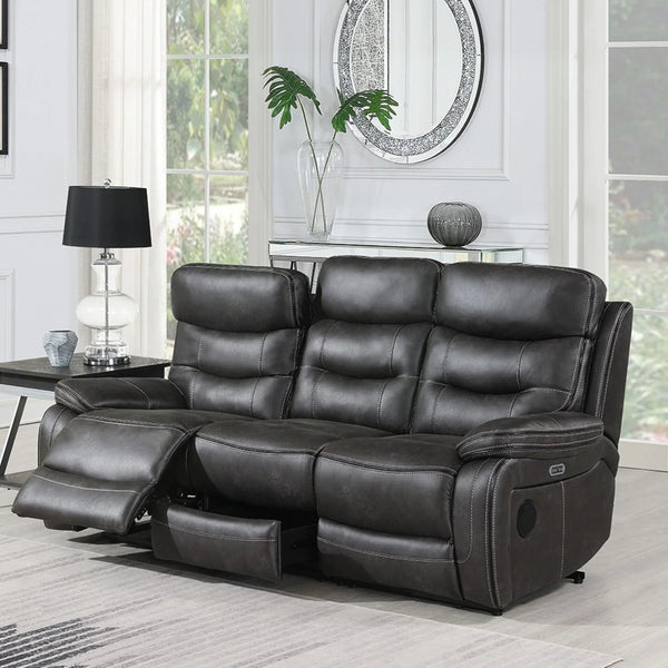 Grey three seater recliner sofa with footrest extended in bright living room setting