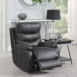 Grey leather recliner chair with padded seat and footrest beside modern lamp table