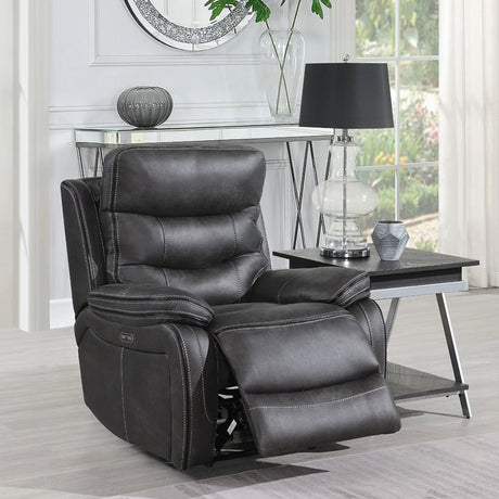 Grey leather recliner chair with padded seat and footrest beside modern lamp table