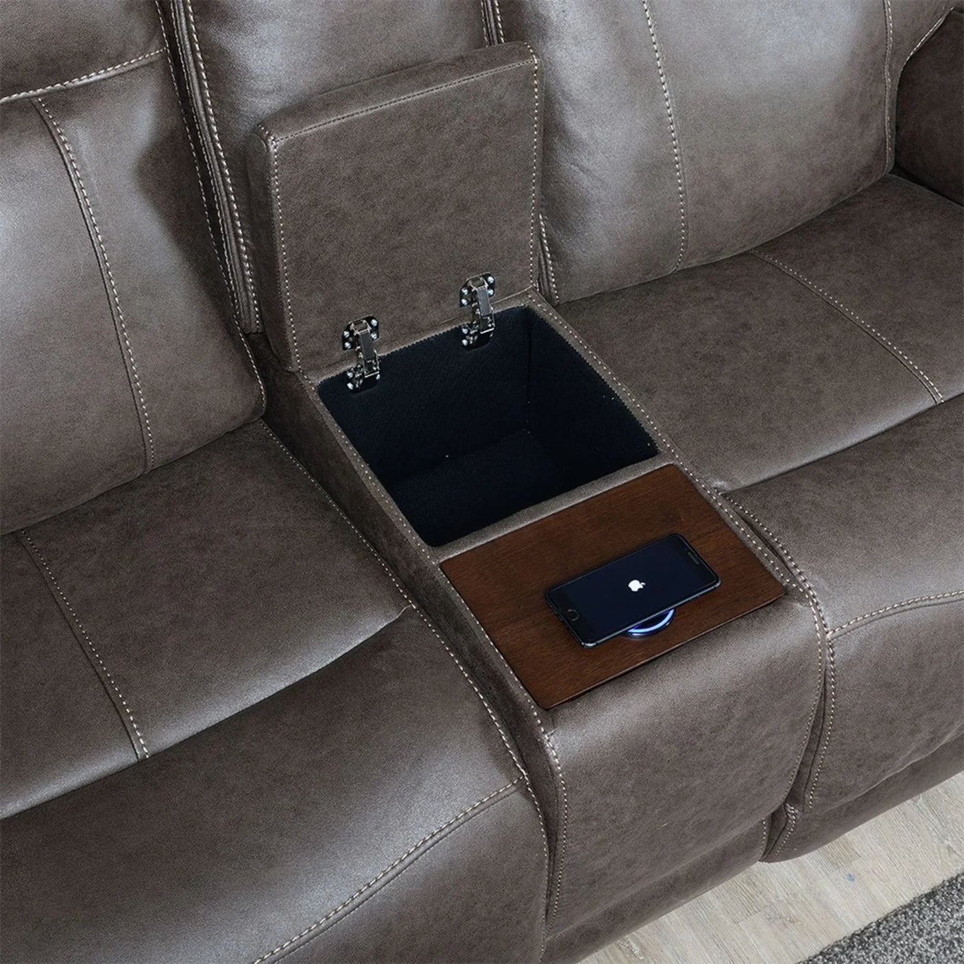 Brown leather loveseat with central console, storage compartment, and wireless charger