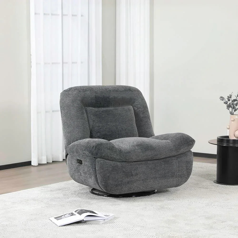 Dark grey reclining chair upholstered in fabric, placed on light rug near side table