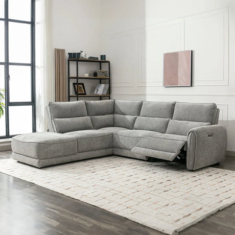 Grey fabric sectional sofa with chaise and recliner set on a light rug in modern living room
