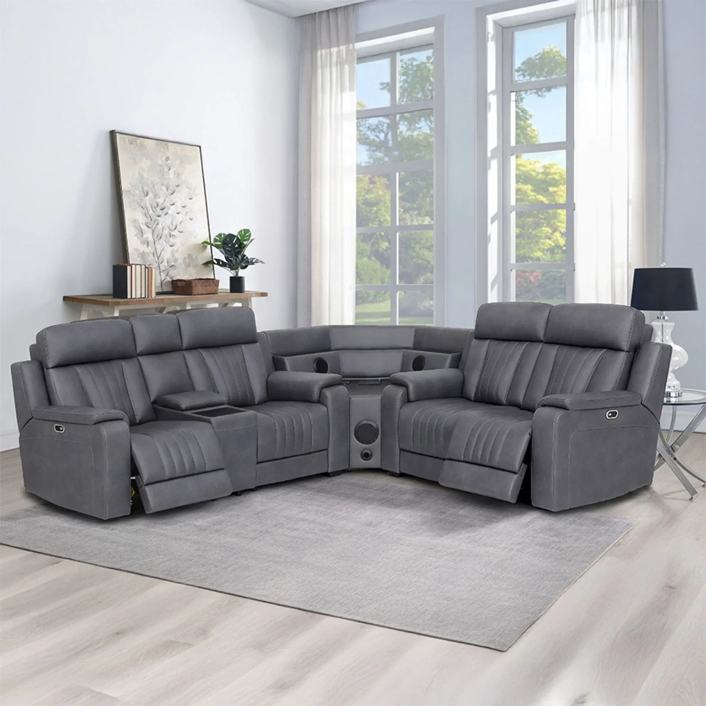 Grey sectional sofa with recliners and cup holders in a bright living room