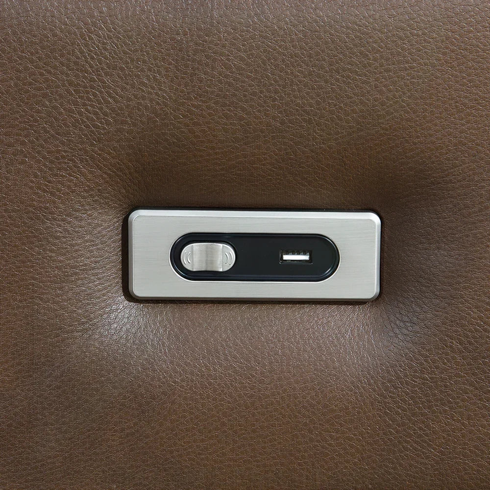Close-up of brown leather sofa USB charging port and power recliner button