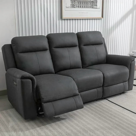 Gunmetal grey recliner sofa with padded seats and one footrest extended in living room