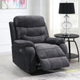 Dark grey reclining armchair with footrest extended beside round black side table and lamp