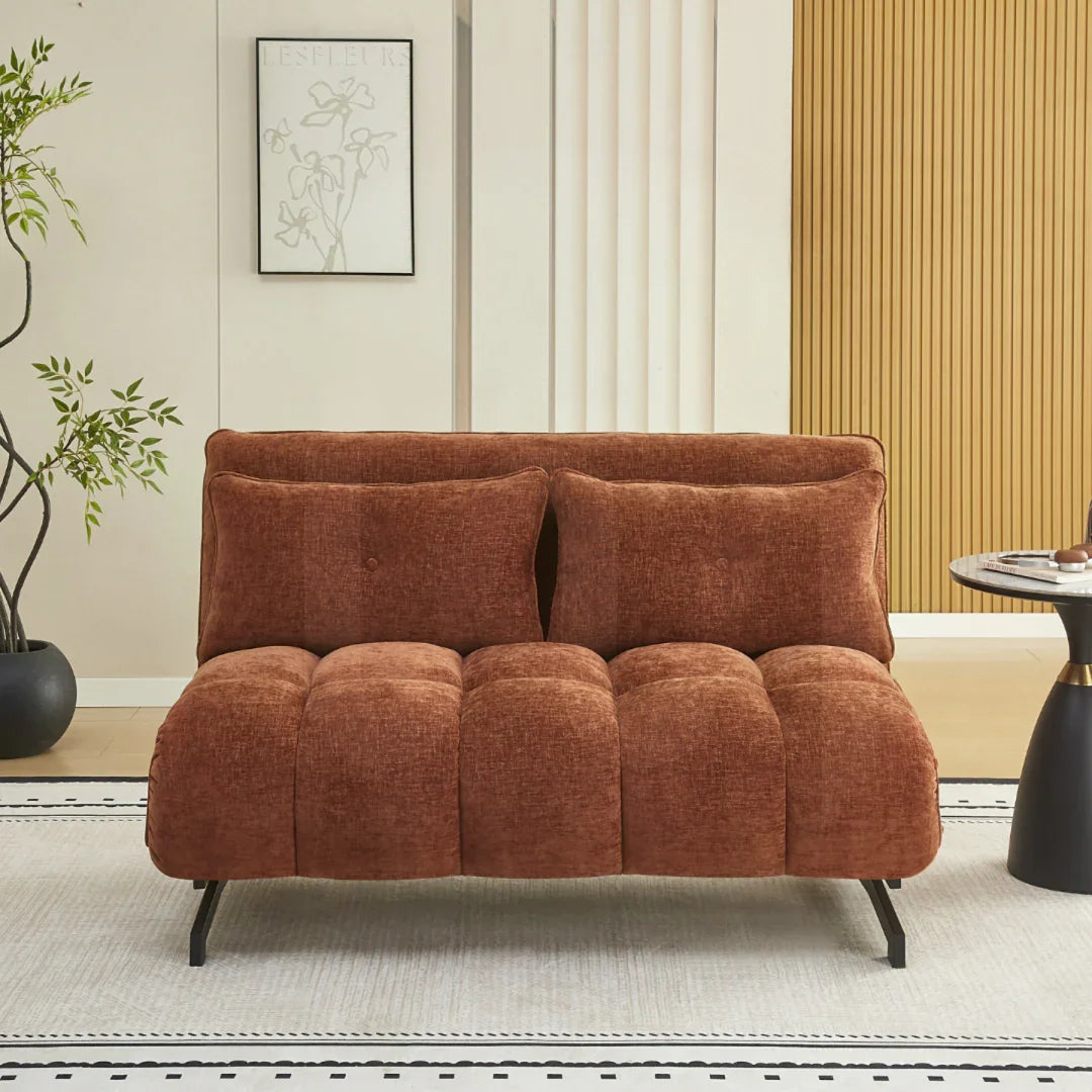 Double sofa bed in deep terra fabric with black legs in modern living room setting